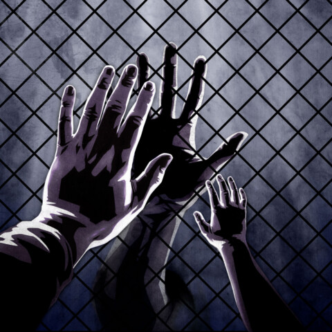 Hands connect through prison visitation window