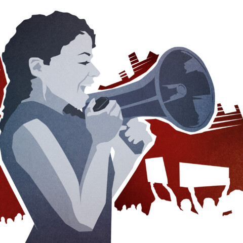 Woman speaks into a megaphone during protest